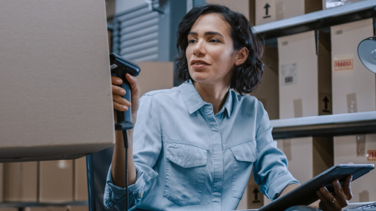 female-inventory-manager-scans-cardboard-box-digital-tablet-with-barcode-scanner-worker-holds-package-background-rows-cardboard-boxes-with-products-ready-shipment